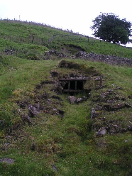 bc_adit.jpg - The Barneycraig Level adit, half filled in with debris. If you look into the adit a canoe can be seen. I wonder if it was used in the level for exploration, as apparently there is deep water all the way.