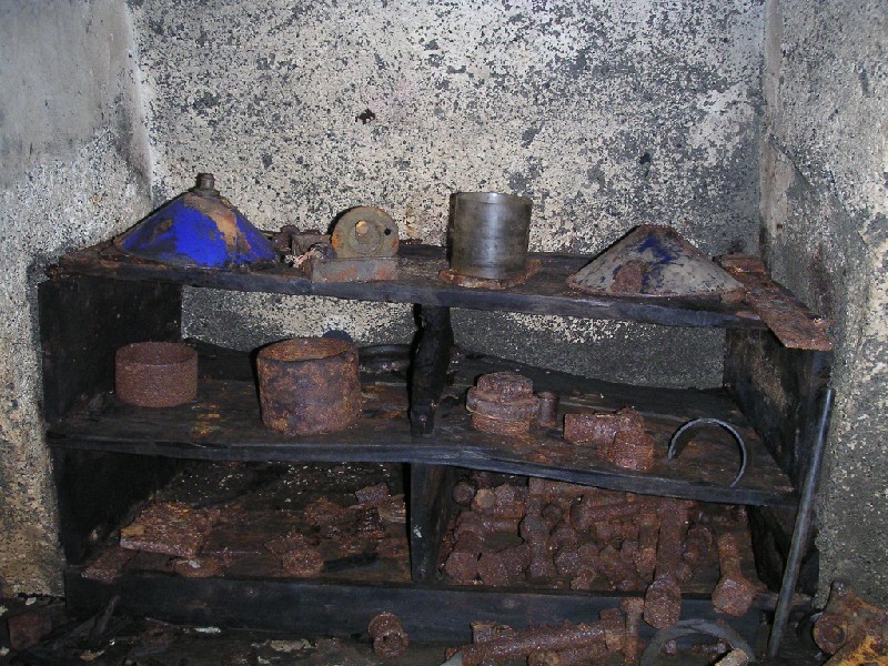 bs_comproom_workbenchshelf.jpg - Shelving on the workbench, full of spare parts and couplings.