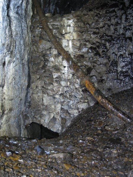 Img_5500.jpg - Walling over a ore chute and manway, with a piece of piping.