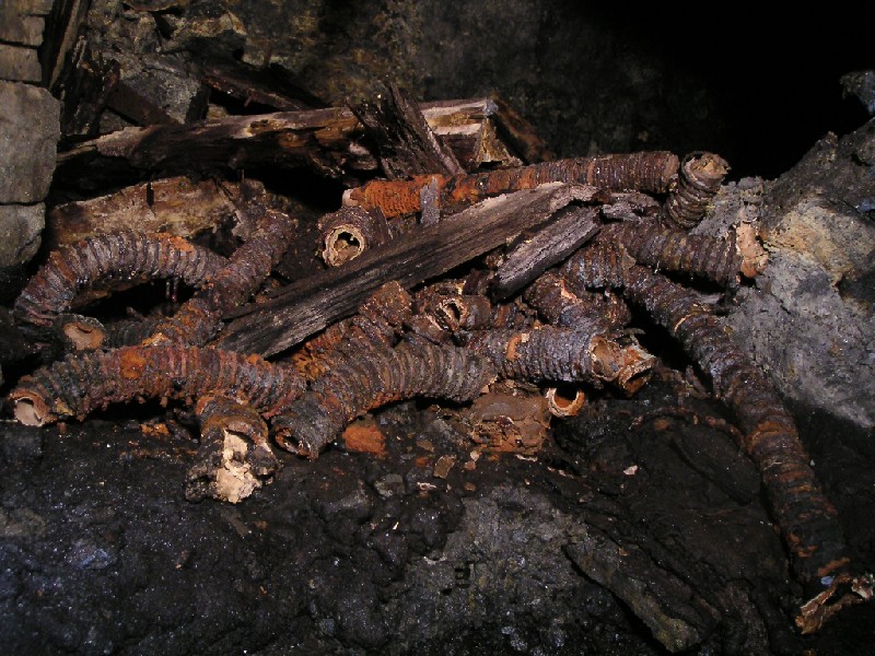 cc_horselevel_airpipes.jpg - At a junction near Hewitson's Rise these pieces of hosing could be seen. We had assumed that these were used for connection to air leg rock drills, but this in not correct. This sort of hosing was placed along the floor and the compressed air was let out to provide 'fresh' air.