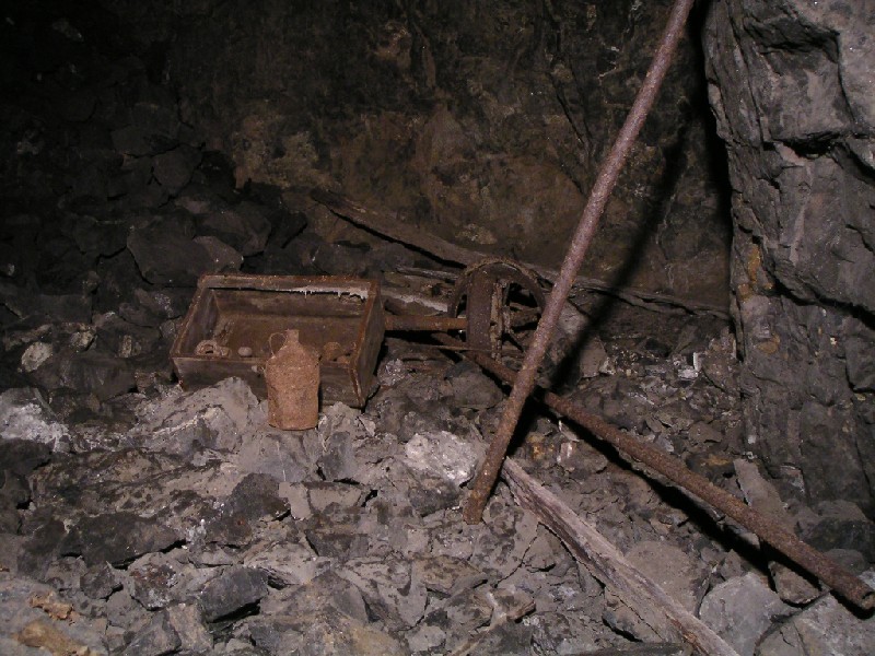 cc_mcnv_stope_boxandartifacts.jpg - Next to the newspaper these arefacts could be seen, a wooden box with big bolts, and pipe fittings.