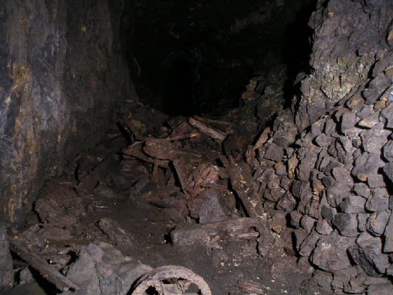 cc_mcnv_stope_collapsedtrucks.jpg - Further along in the stope we came to this large pile of debris with wheels scattered all over the place.