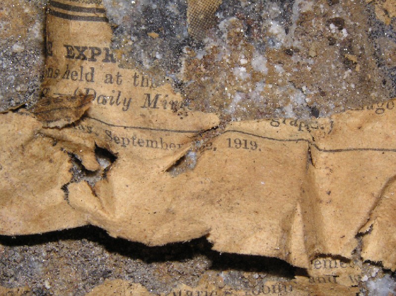 cc_mcnv_stope_newspaper2.jpg - Close up of an old newspaper in the stope. The date can be cleary seen as September 1919, and it is the Daily Mirror.