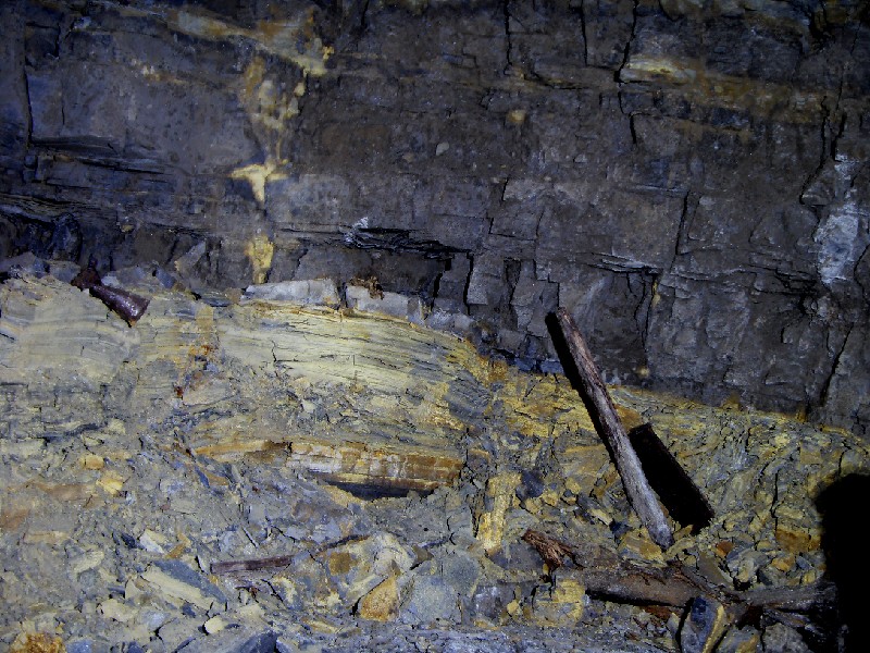 cc01_stope_bate_area1.jpg - Not the most clear photo, but in the stope that we climbed up into we found this bate area. To the bottom right you can see part of a bench, middle left, a can and some rags.