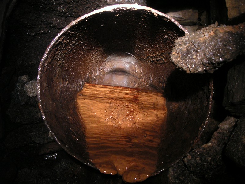 cch_drainagepipe2.jpg - Again, just inside the main adit, this drainage (?) pipe can be seen. It looks like a micro level for pigmy explorers.