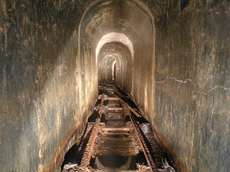 cch_spillway_rails1.jpg - Further in and the planks get replaced by rails. The spillway is something completely different in Nenthead, more like a sewer.