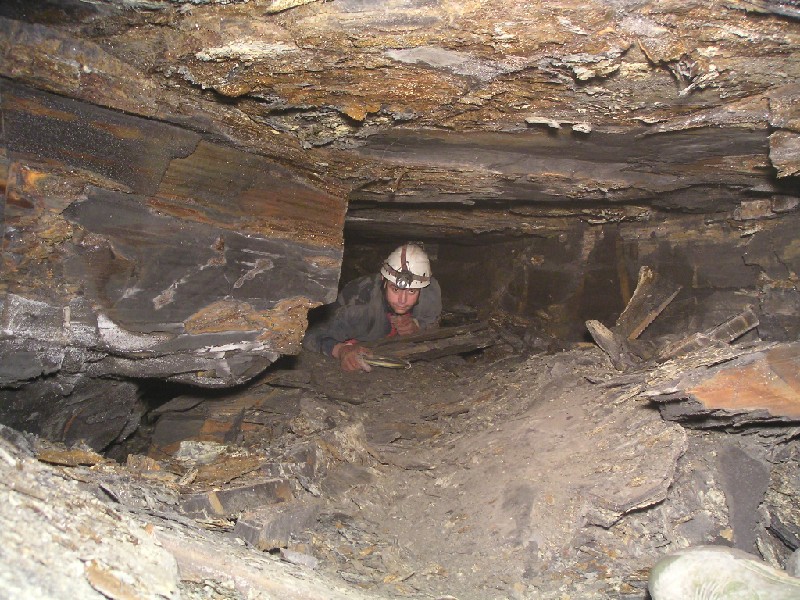cch_eastsidepassage_crawl2.jpg - Crawling along the southeast passage, these are above arching sections that are blocked.
