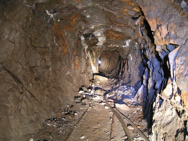 cm_insidetoplevel1.jpg - View towards the portal on in the middle level. Remains of compressed air hosing can be seen snaking away on the floor.