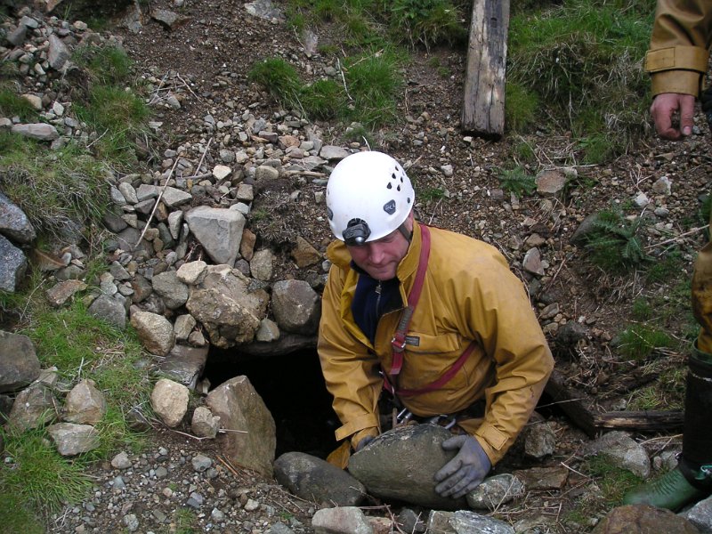 cm_lowlevel_adit2.jpg - Bernie clearing some rocks in front of the low level adit.