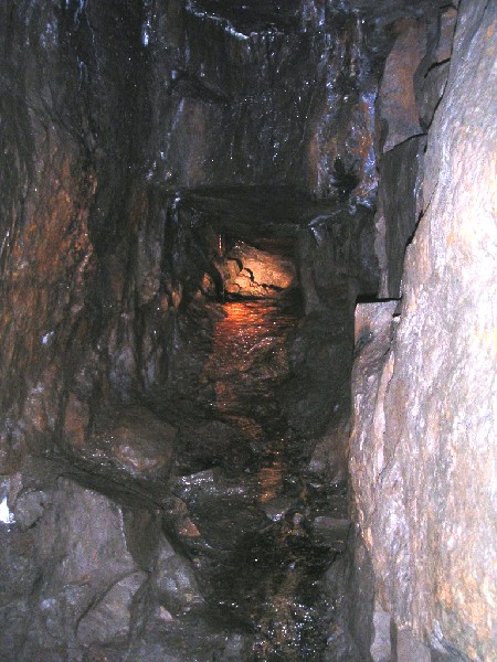 cl_ironstal1.jpg - Iron stained stalactite growing in the Hammer Head working, also causing an iron stained flow.