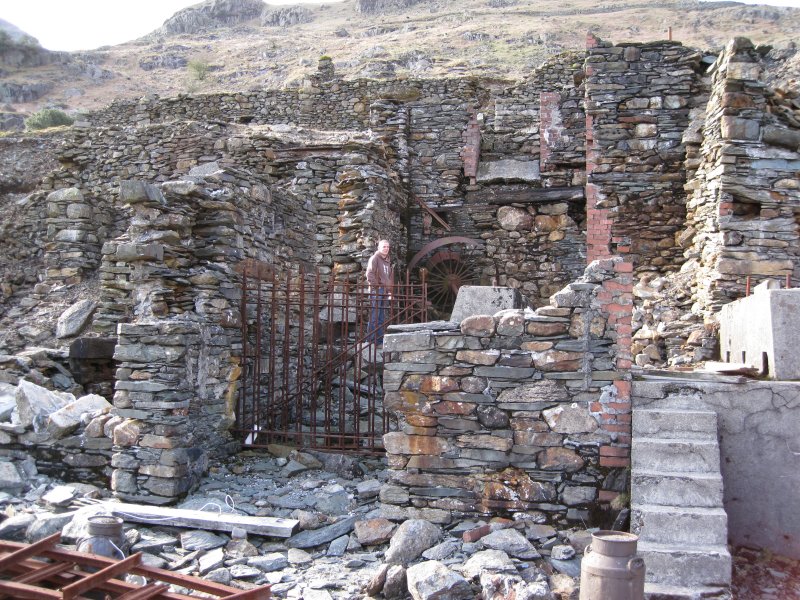IMG_0403.jpg - This stone work and terraces formed the main part of the mill. The terrace that Karli is standing on had the water wheel for the jiggers and crushers. The higher terrace behind him was the site of the stamps and cobbling floors.