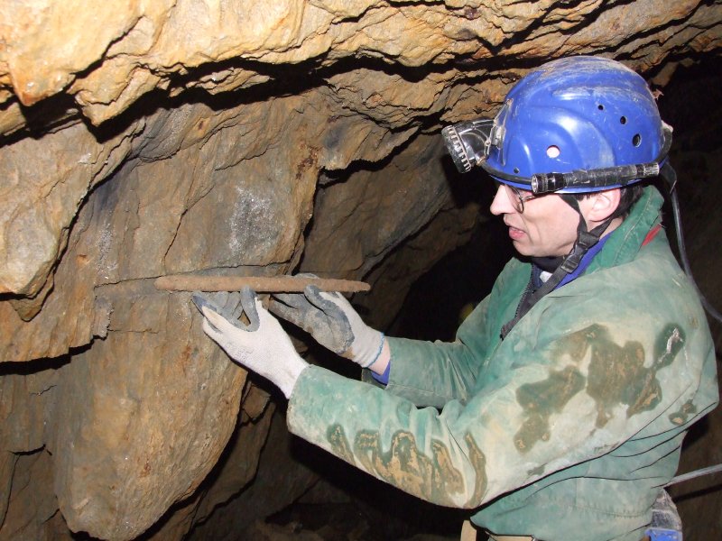DSCF9139.jpg - Pete examining a shot hole and a wooden tamping rod. Photo by Paul.