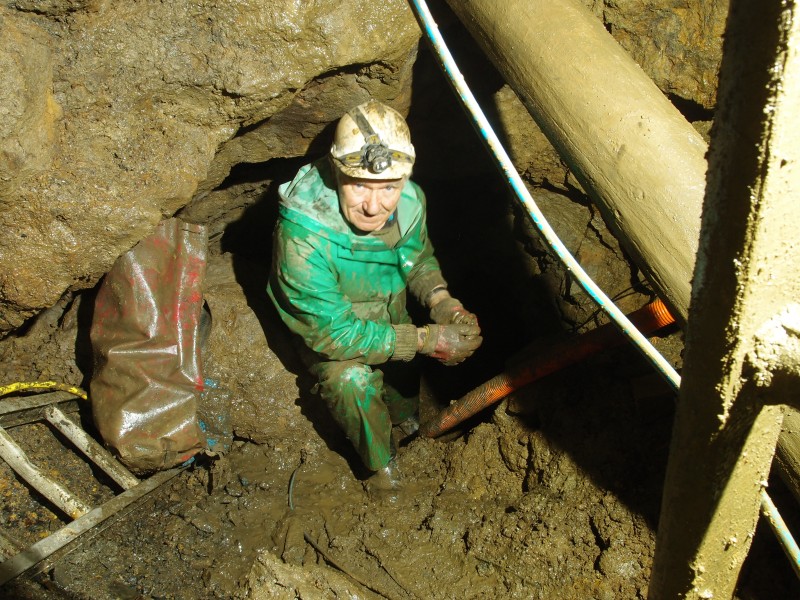P1122324.JPG - Bottom of the shaft, with Mick at the entrance to the working.