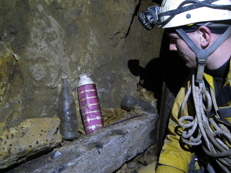 IMG_1639.jpg - Old bottle and flask at the tee junction. The piece of metal to the bottom right of the flask is a saw blade.