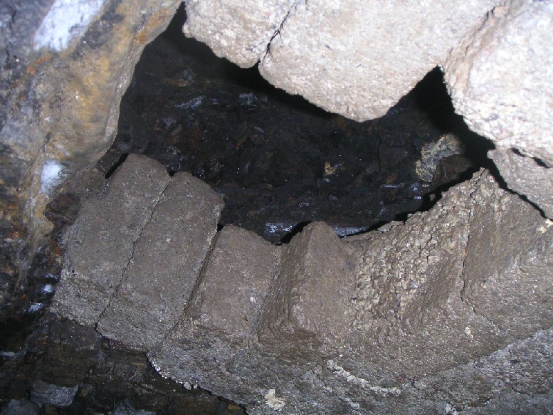 ghg_riseintostope.jpg - The actual rise into the stope looks like it is an ore shoot, as some of the original wood is still in place. If it had not been for the missing blocks this rise may have been totally missed as the hopper was 'bricked up'. It makes you think of how many hidden entrances in the mines are walled up and forever missed?