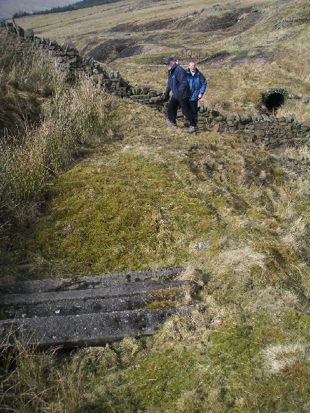 gudhamgillhighlevel_entrance2.jpg - Sleepers covering a hole in the Gudhamgill Level. The 'adit' in the background is a culvert for the gill.