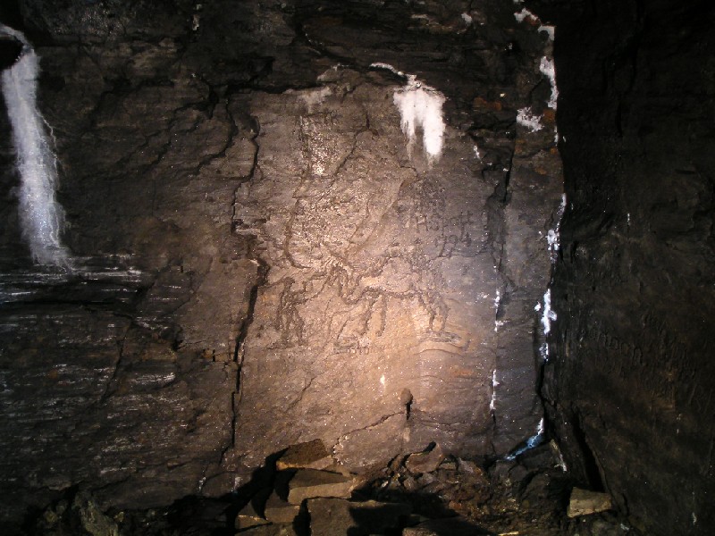 mc_mcnv_camelgraf1.jpg - At the first sump we came to along this branch, we saw this chiselled picture of a camel, if you look closely, there is a person leading it with a turban and a figure riding it. Underneath it, is the name of a single humped camel 'Dromedary'. It looks like this was done by H. Spott in 1794. Around the camel is also a sort of cross hatching which looks like it could be depicting hills or mountains. Where a mine worker would have seen a camel leads to some speculation, a zoo, in a book, or possibly he may have been involved in some military campaign in Africa or the Middle East?