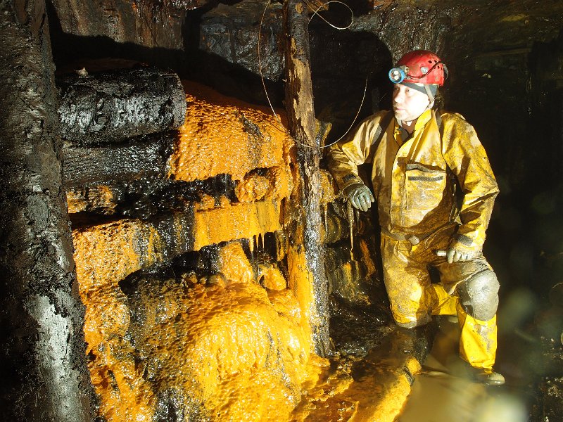 P6123875.JPG - Iron stained calcite flow over timbers.