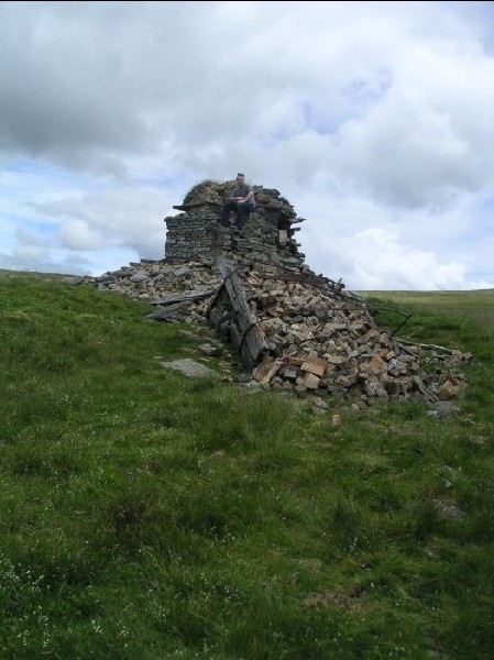 flue8.jpg - View of the base and the collapsed chimney. The iron bars are part of the strapping used to support it.