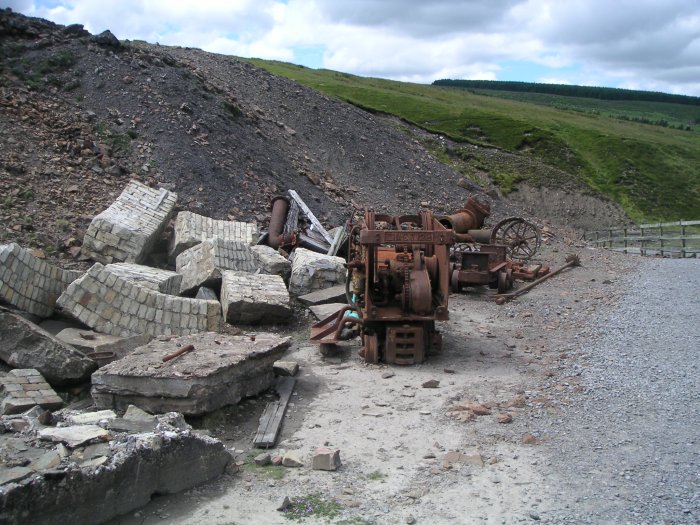 rockershovel.jpg - An old rocker shovel used for clearing up ore and waste rock, along with some arches from the smelt mill.