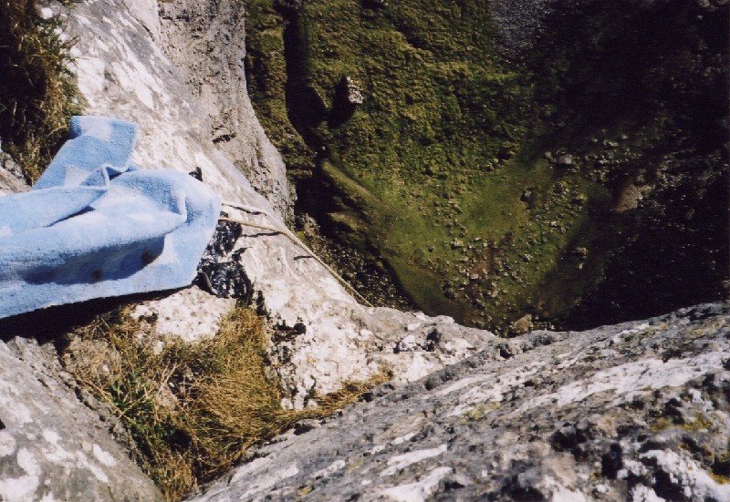 malhamcove4.jpg - Looking down, things are very small, the drop depending on where you look it up is between 70 and 80m. We did put a mat on those rub points.