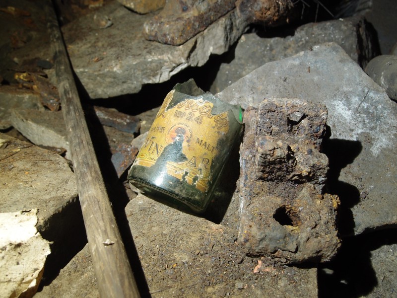 P2118031.JPG - Broom handle, broken bottle of malt vinegar and rail shoe.