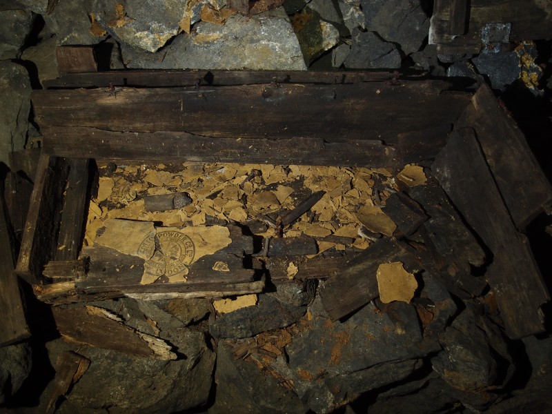 P2118105.JPG - Another explosive box with fuse, gunpowder wrappers and detonator tins.