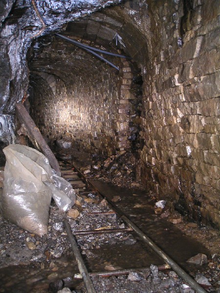 rg_ramseys_sump.jpg - The passage way just by the side of Ramsey's Sump. The water can be seen heading towards it. This sump if not blocked should go all the way to the Four Fathom Limestone, some 30 - 40m below.