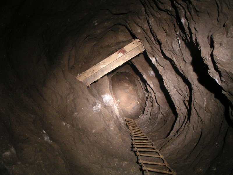 rg_riseintonorthstringpastrg_shaft.jpg - At the very end of the passage on the otherside of the shaft is this rise, which takes you up into the North String and eventually to the Boundary Cross Vein and flats. It is possible to work your way down back in the Rampgill Horse Level via the flats. This was the route before the shaft was bridged.