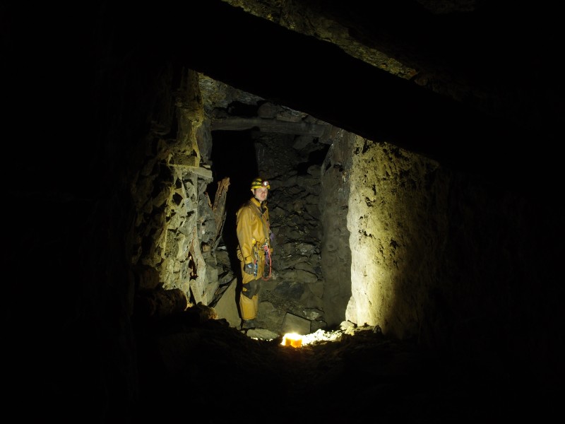 PB081454.JPG - Level at the top of the Great Limestone, looking northwest, Pete standing next to another ore chute.