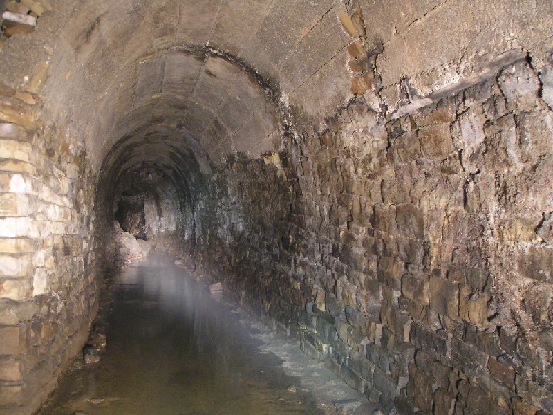 rg_passagepastbrewery.jpg - Continuation of the main passage into Rampgill, just around the corner from the Brewery Shaft. Note the more recent concrete lining of the roof.