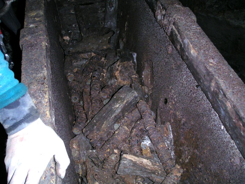 sc_longcleughvein_oretrucknearforehead1.jpg - Past the rise we came to this well preseved ore truck with parts of air hosing in it.