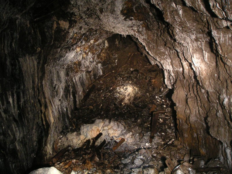sc_mcssv_stope.jpg - View out across the stope east from the rise. There is heavy calcification and a lot of debris where timbers have rotted and dropped their load of stacked deads.