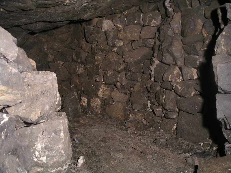 sc_wfs_1ststopelevel.jpg - A bit of wooden planking on the floor in the first level of the stoping. At first we thought this may have been a covered ore shoot, but on removing one of the planks, it was found to be solid.