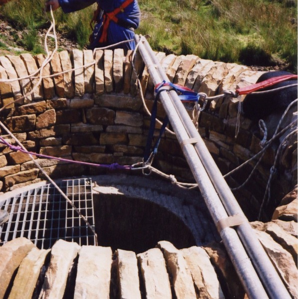 surfaceshaft2.jpg - Rigging the shaft up for decent. This was our first big SRT and our 50m rope just about reached the bottom. Looking at this, I think we over killed the number of anchors.