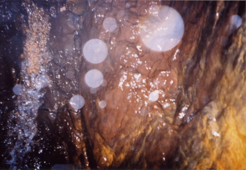 surfaceshaft6.jpg - This was the bottom of the shaft, it ended in a sump with a lot of water pouring into it. On the way down we passed 2 levels or workings which had ladders in them and a lot of debris. Being our first big SRT for we did not fancy swinging in.