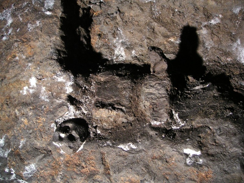 ss_candleandclay.jpg - Stuck on the wall, a ball of clay with finger indentations, to the right a candle - you can just about see the wick.