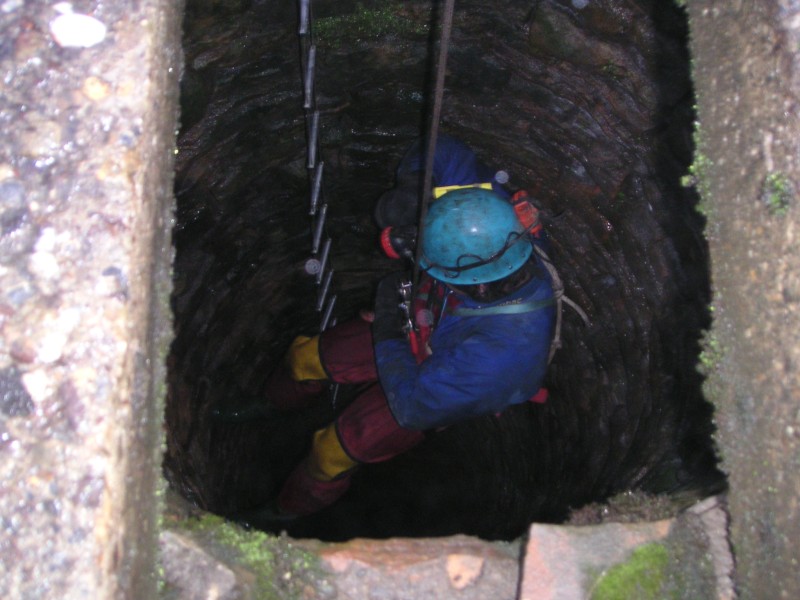 ss_decent.jpg - Charlie starting to abseil down, much warmer out of the weather.