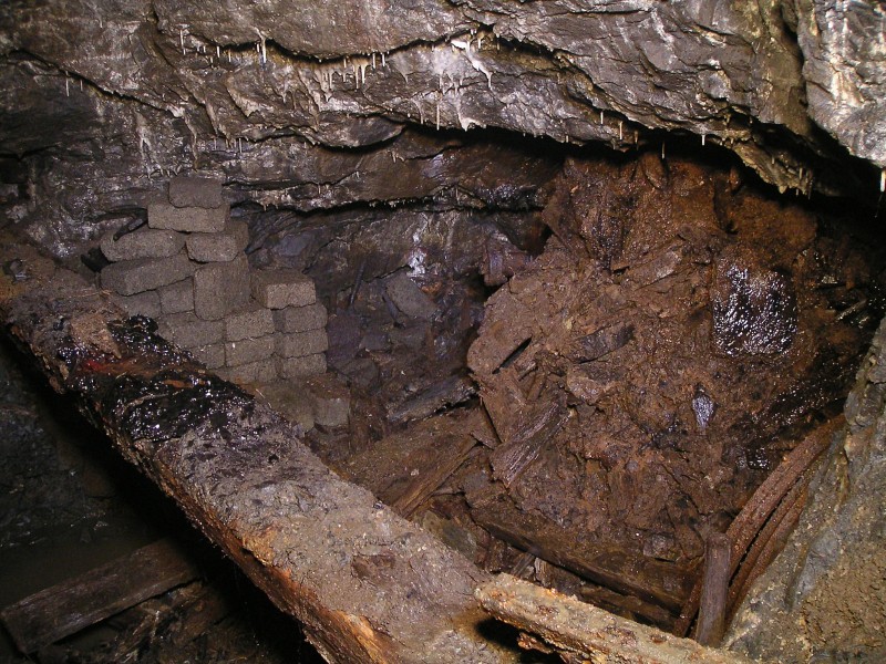 wgs17_drop_downstream2.jpg - Looking to the right the debris from the shaft can be seen spilling in. To the bottom right you can see the stack of arch formers.