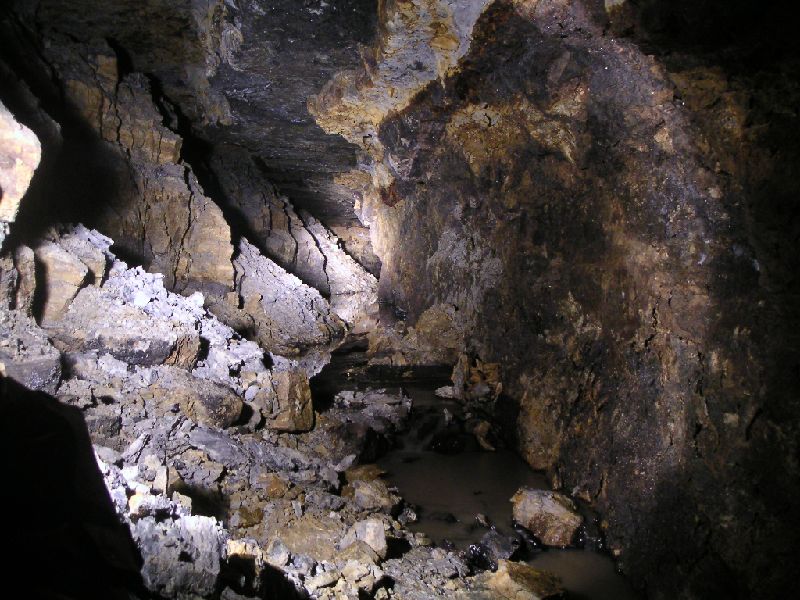 brownleyh_gbxvein_collapse.jpg - Some time after we limestone part of the passage, we started to encounter a few collapses of orche, which seems to be the cause of the water back up.