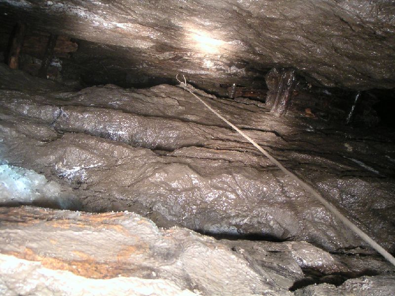 brownleyh_sumpstope_exit.jpg - Looking up the sump and stope that links to Brownley Hill. You can see the stemples holding up some of the wooden platforms in the stope. The whole drop is around 35m, there are many rub points and ideally the anchors could be redone just in case you have to go back up.